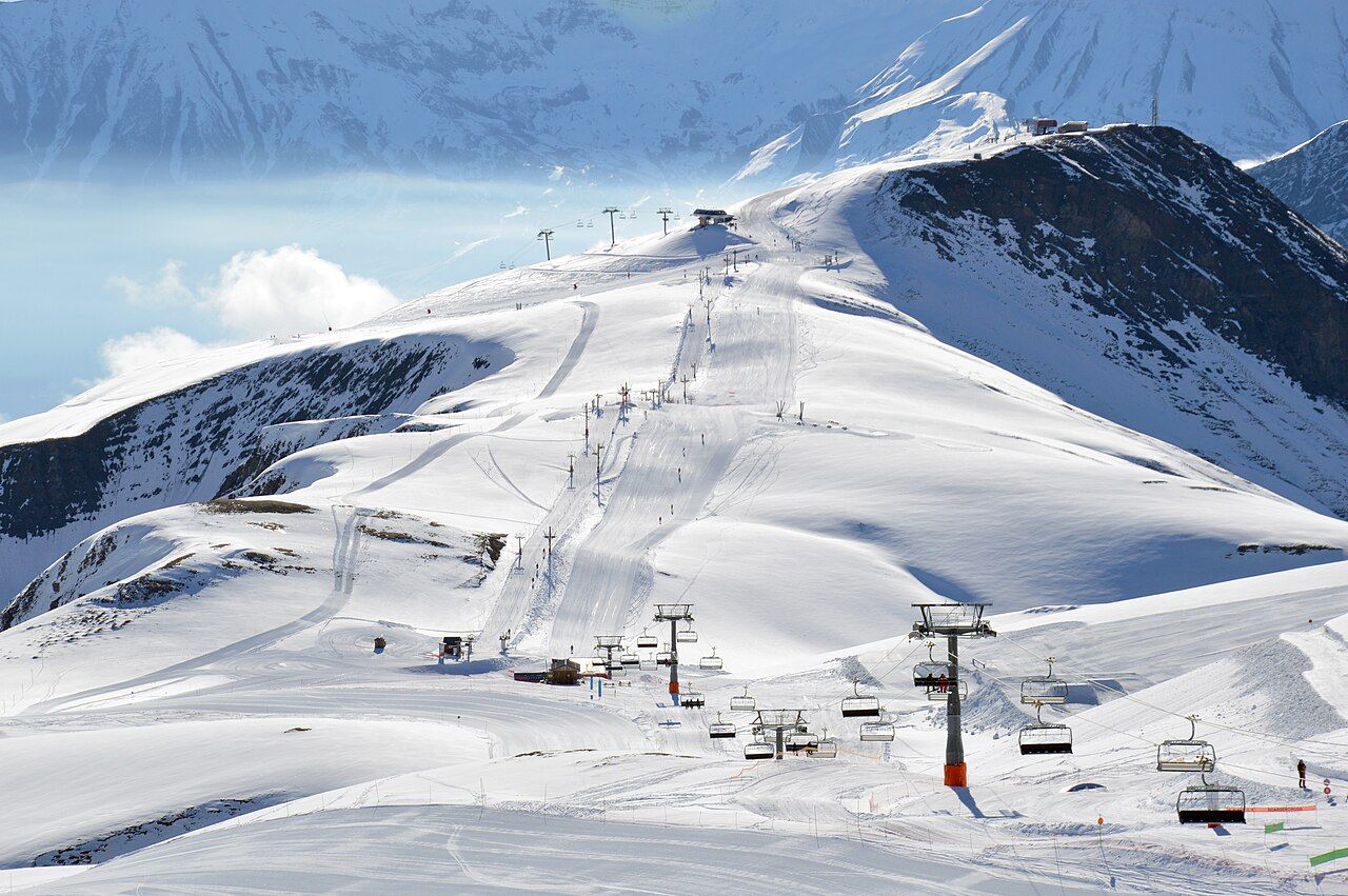 Chairlifts running up snowy ski slopes